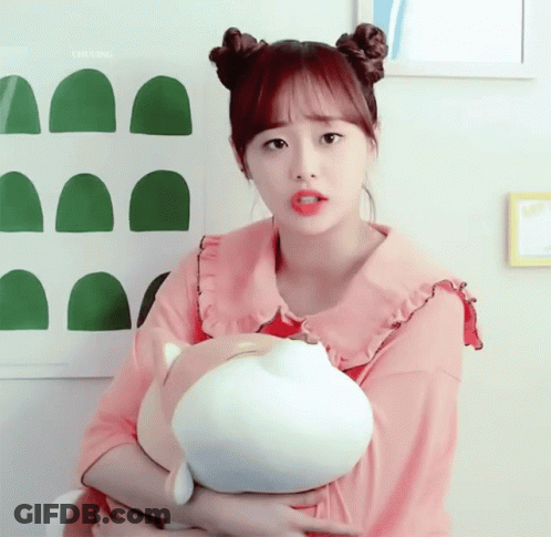 A Girl In A Pink Shirt Is Holding A Stuffed Animal In Her Arms And The Word Chuling Is Above Her GIF