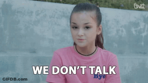 A Girl In A Pink Shirt Is Saying `` We Make Money Moves '' While Sitting On A Bench . GIF