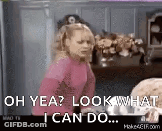 A Girl In A Pink Shirt Is Standing In A Kitchen And Saying `` Oh Yea ? Look What I Can Do . '' GIF