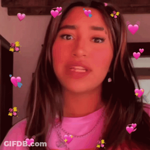 A Girl In A Pink Shirt With Hearts On Her Hair GIF