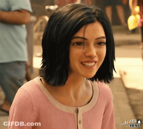 A Girl In A Pink Shirt With The Word Alita Written On The Bottom GIF