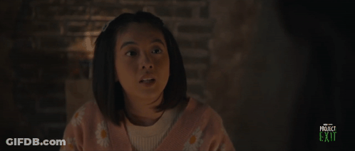 A Girl In A Pink Sweater Is Smiling In A Project Exit Advertisement GIF