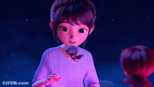 A Girl In A Purple Shirt Is Holding A Stuffed Animal In Her Hand GIF
