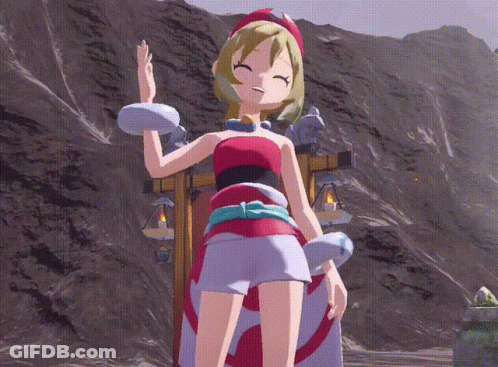 A Girl In A Red And White Dress Is Standing In Front Of Mountains GIF
