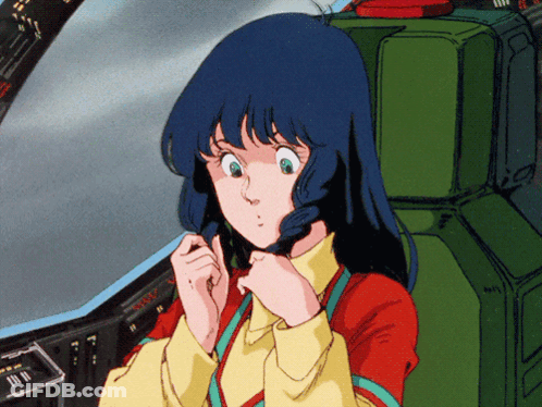 A Girl In A Red And Yellow Shirt Is Sitting In A Green Seat GIF