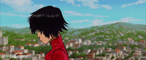 A Girl In A Red Jacket Stands In Front Of A Town GIF