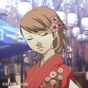 A Girl In A Red Kimono With Flowers In Her Hair GIF