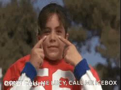 A Girl In A Red Shirt Is Making A Funny Face With Her Hands . GIF