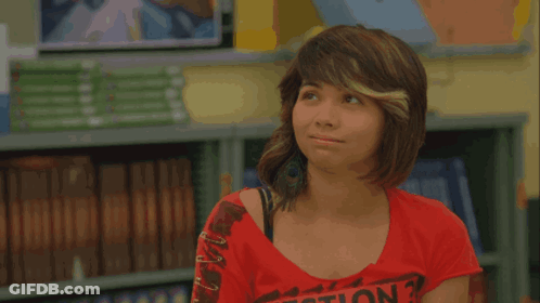 A Girl In A Red Shirt Stands In Front Of A Yellow Sign That Says Pass GIF