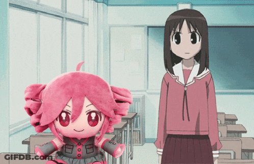 A Girl In A Red Skirt Stands Next To A Stuffed Doll With A Pink Hair GIF