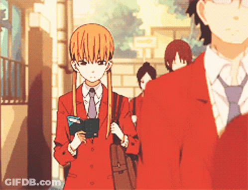 A Girl In A Red Suit And Tie Is Standing Next To A Man In A Red Suit GIF