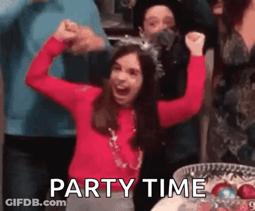 A Girl In A Red Sweater Is Raising Her Arms In The Air While A Group Of People Are Standing Around Her . GIF