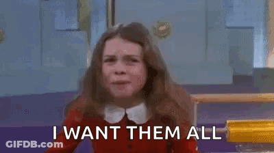 A Girl In A Red Sweater Is Saying `` I Want Them All '' With Her Arms In The Air . GIF