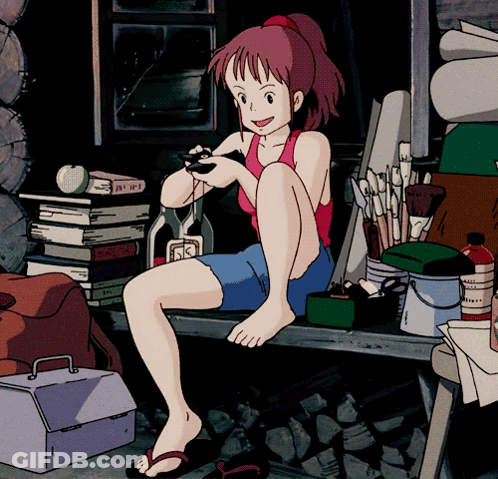 A Girl In A Red Tank Top Sits On A Bench Holding A Remote Control GIF