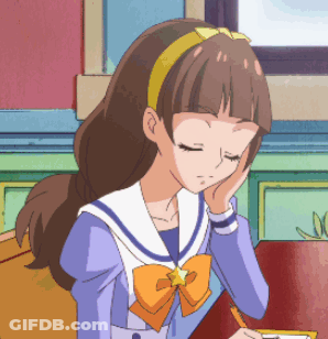 A Girl In A Sailor Suit With A Star On Her Head Is Sitting At A Table With Her Eyes Closed GIF