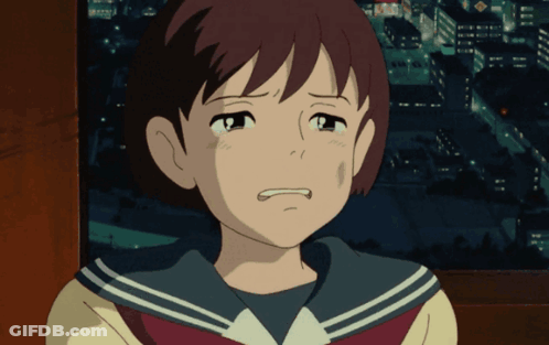 A Girl In A School Uniform Is Crying In Front Of A City GIF