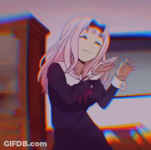A Girl In A School Uniform Is Dancing In A Room With A Blurry Background . GIF