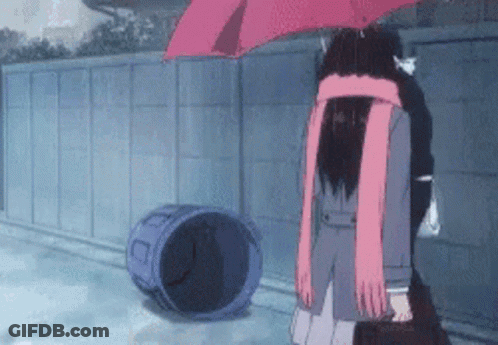 A Girl In A School Uniform Is Holding An Umbrella In The Rain While Standing Next To A Trash Can . GIF