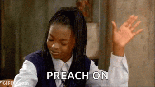 A Girl In A School Uniform Is Sitting At A Table With Her Hands In The Air And The Words Preach On Written Next To Her . GIF