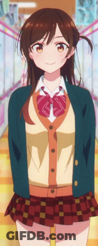 A Girl In A School Uniform Is Standing In A Hallway With Her Hands Behind Her Back . GIF