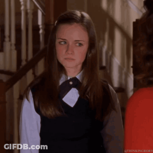 A Girl In A School Uniform Is Standing Next To A Woman In A Red Shirt GIF