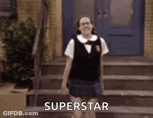 A Girl In A School Uniform Is Standing On A Set Of Stairs And Says Superstar . GIF