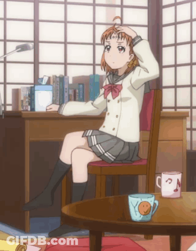 A Girl In A School Uniform Sits In A Chair With Her Hand On Her Head GIF