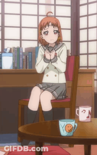 A Girl In A School Uniform Sits On A Chair Next To A Table With A Cup That Says Smiley Face On It GIF
