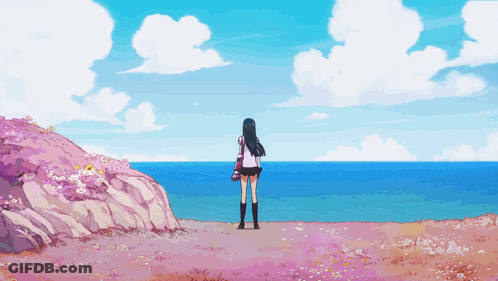 A Girl In A School Uniform Stands On A Hill Overlooking The Ocean GIF