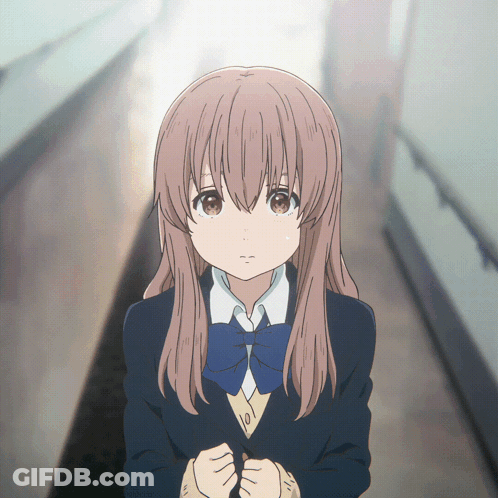 A Girl In A School Uniform With A Blue Bow Tie Is Standing In A Hallway GIF