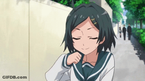 A Girl In A School Uniform With A X On Her Hair Is Smiling GIF