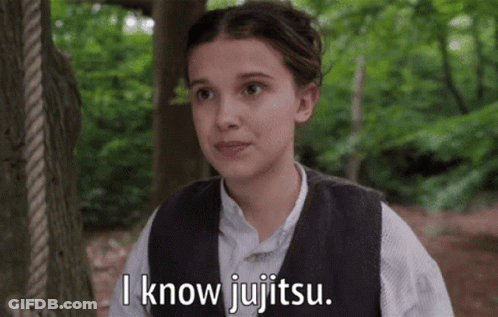 A Girl In A Vest Says I Know Jujitsu In Front Of A Tree GIF