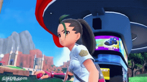 A Girl In A Video Game Is Standing In Front Of A Sign That Says Tomy GIF