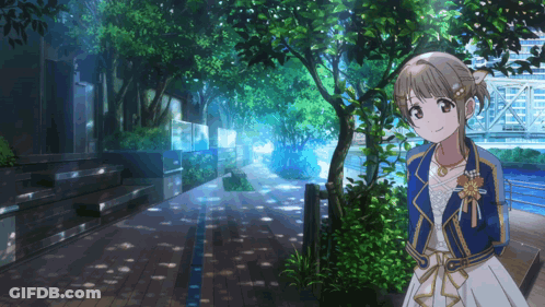 A Girl In A White Dress And A Blue Jacket Stands On A Sidewalk GIF