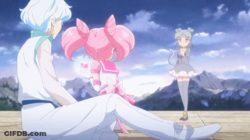 A Girl In A White Dress Is Standing Next To A Boy In A White Suit GIF