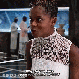 A Girl In A White Tank Top Is Asking Why Do You Have Your Toes Out In My Lab GIF