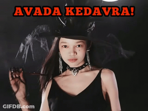 A Girl In A Witch Costume Is Holding A Glowing Object And The Caption Says Avada Kedavra GIF