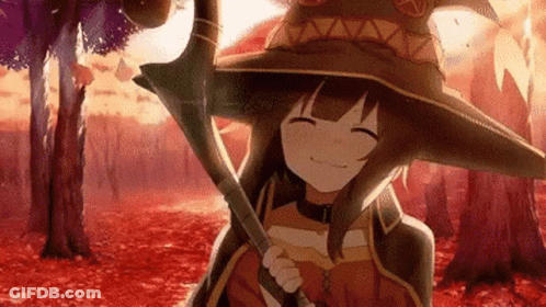 A Girl In A Witch Hat Is Holding A Cane In A Forest . GIF