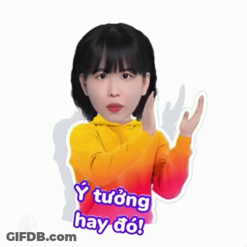 A Girl In A Yellow Hoodie Is Making A Peace Sign With Her Hand . GIF