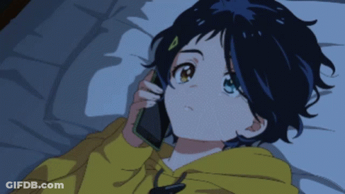 A Girl In A Yellow Hoodie Is Talking On A Phone GIF