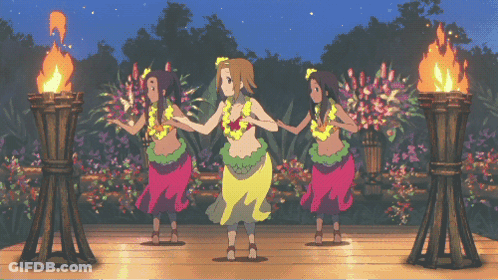 A Girl In A Yellow Skirt Is Dancing In Front Of Two Torches GIF