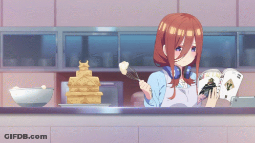 A Girl In An Apron Is Reading A Magazine While Cooking GIF