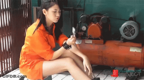 A Girl In An Orange Jumpsuit Sits Next To An Air Compressor With The Words Collaboration Project On The Bottom GIF