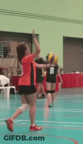 A Girl In An Orange Shirt With The Number 8 On Her Back GIF