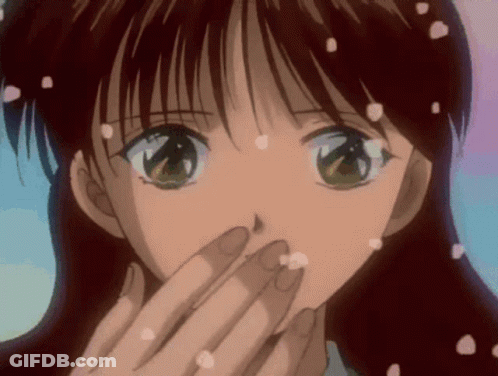 A Girl Is Covering Her Mouth With Her Hand And Petals Are Falling From Her Hair GIF
