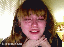 A Girl Is Crying With Her Eyes Closed And Her Mouth Open GIF
