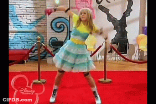 A Girl Is Dancing On A Red Carpet In A Room . GIF