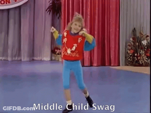 A Girl Is Dancing On A Stage And The Words Middle Child Swag Are On The Bottom Of The Screen GIF