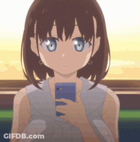 A Girl Is Holding A Cell Phone In Her Hand GIF