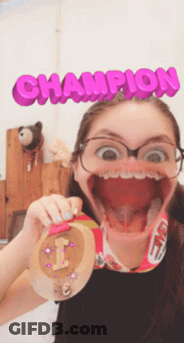 A Girl Is Holding A Medal With The Word Champion Behind Her GIF